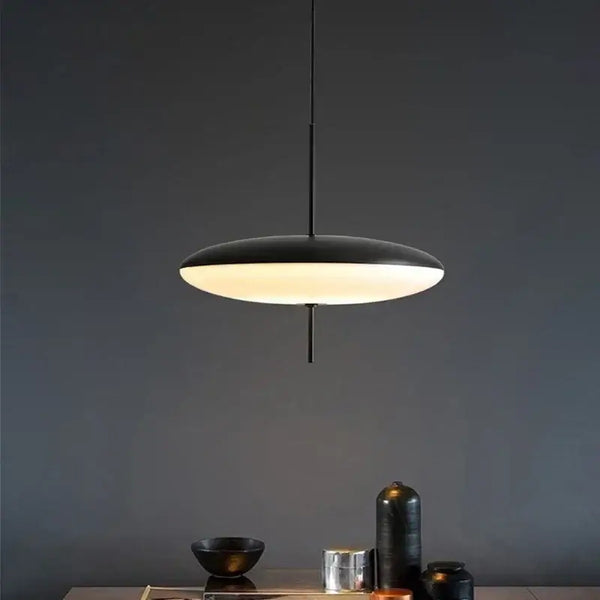 Nordic LED Pebble Pendant Light – Minimalist Ceiling Lamp hanging over a stylish dining table with sleek decor.