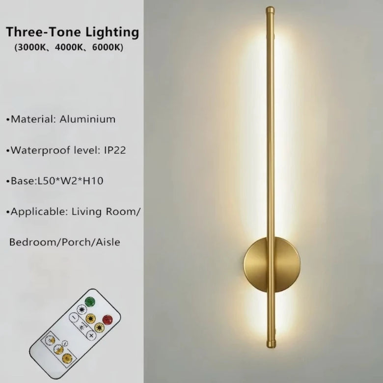 Three-tone slim wall sconce light fixture in brushed gold/brass finish with a circular backplate and vertical light bar, shown lit on a light gray wall. Left side includes text specs ('Three-Tone Lighting', material aluminium, waterproof IP22, base dimensions, applicable rooms) and a small remote control illustration.