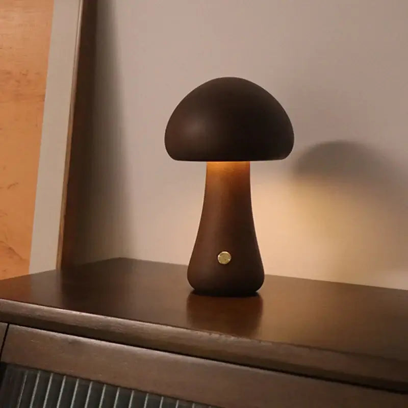 Portable Dimmable 60s Italy Designer Mushroom Table Lamp glowing on a wooden surface. Perfect for travel and adjustable brightness.