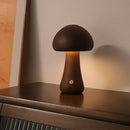 Portable Dimmable 60s Italy Designer Mushroom Table Lamp glowing on a wooden surface. Perfect for travel and adjustable brightness.