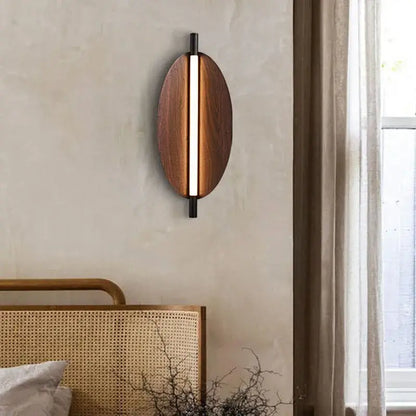 Modern Brown Leaf Wall Light – Sculptural LED Wall Sconce in Metal illuminating a bedroom wall.