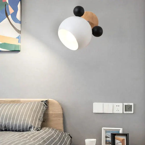 Mouse-shaped Wall Lamps on wall above modern bed, adding playful style and energy-efficient lighting to the room.