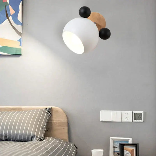 Mouse-shaped Wall Lamps on wall above modern bed, adding playful style and energy-efficient lighting to the room.