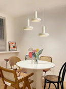 60s Scandinavian Style Kitchen Pendant Lamp hanging above a round white table surrounded by stylish chairs in a modern kitchen.