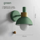 Pull Chain Nordic Sconce in green with a pull chain switch, featuring a round shade and wooden accents for a child's room.