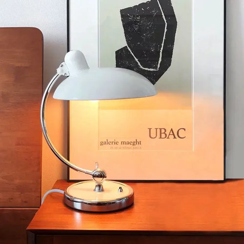 Bedside Table Lamp - Timeless Design and Modern Functionality on a wooden table with minimalist artwork behind it.