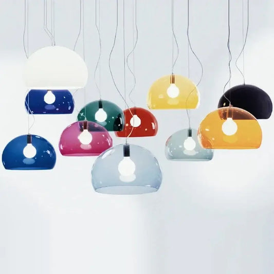 hero A set of modern pendant lamps with translucent dome-shaped glass shades in multiple colors, including white, blue, green, red, yellow, orange, and black, hanging against a light gray background.