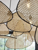 Mid-Century Modern Rattan Wall Light showcasing woven design and warm lighting ambiance in a retro style.