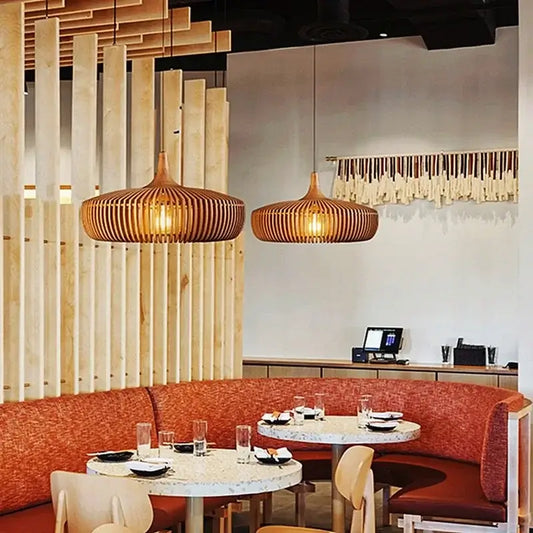 Vintage Wooden Pendant Light – Handcrafted Nordic Birdcage Lamp illuminating a stylish dining area.