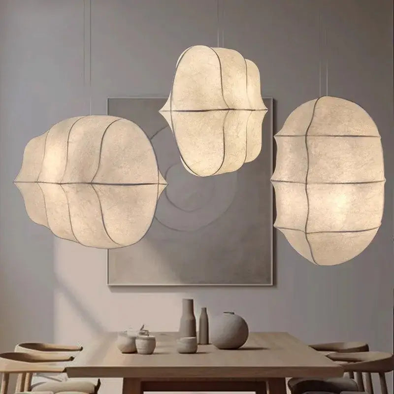 Japanese Wabi-Sabi Silk Pendant Light – Sculptural White Hanging Lamp illuminating a dining area with elegant, tranquil design.