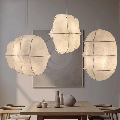 Japanese Wabi-Sabi Silk Pendant Light – Sculptural White Hanging Lamp in a modern dining setting.