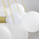 Contemporary Frosted Glass Ball & Gold Chain Chandelier showcasing opulent design with frosted glass balls and golden chains.