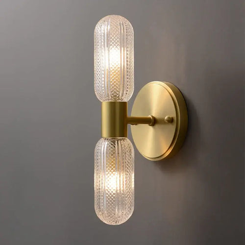 Radiant Luxe Gold Wall Sconce featuring sleek gold finish and clear glass for modern indoor elegance.