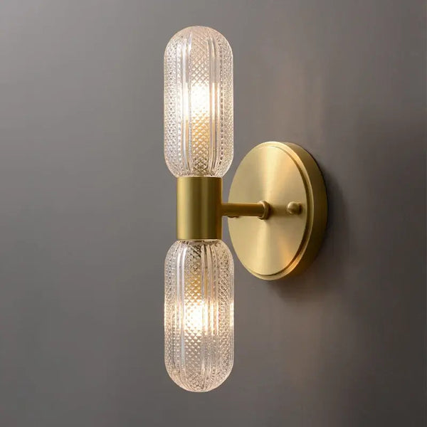 Radiant Luxe Gold Wall Sconce featuring sleek gold finish and clear glass for modern indoor elegance.