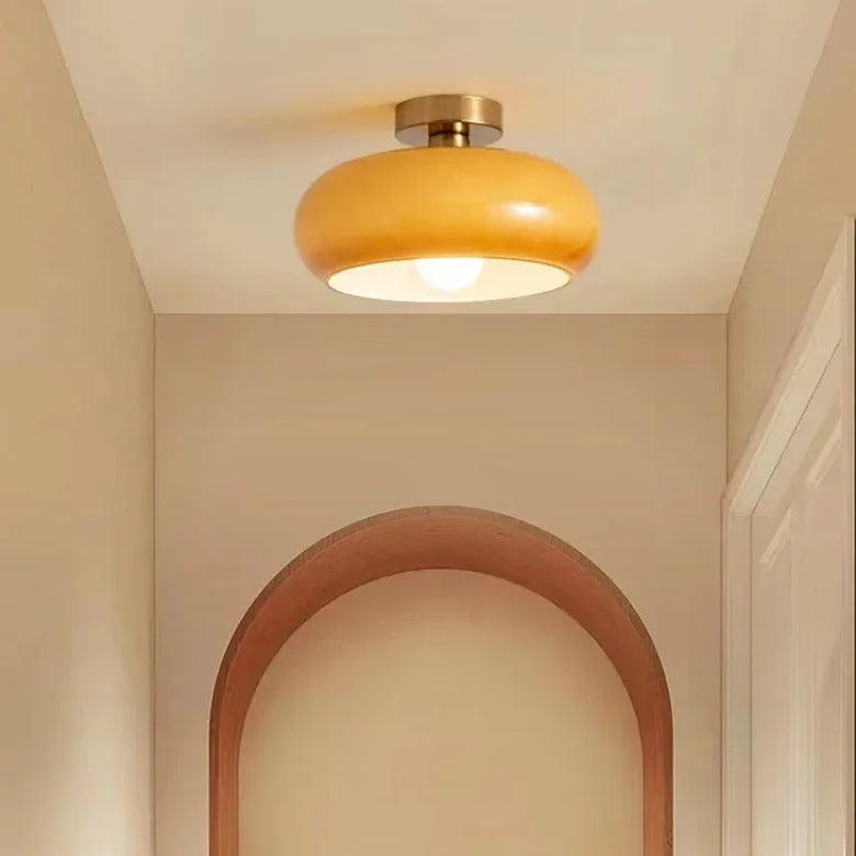 Ceiling light fixture in a room with a wooden archway