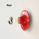 80s revival wall light in vibrant red UFO shape with silver bulb, perfect for adding retro style to any room.