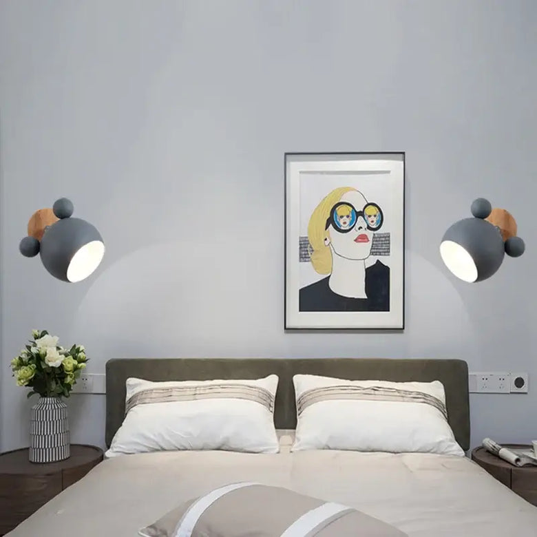 Mouse-shaped Wall Lamps illuminating a stylish bedroom with playful decor and modern design elements.