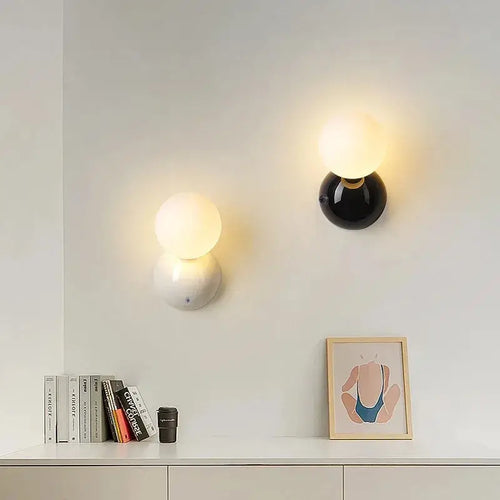 70s revival wall lamp in 3 different colours mounted on a wall with frosted glass ball and painted metal base.