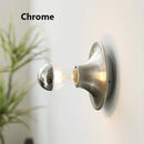 80s revival wall light in chrome finish with UFO shape and glowing bulb.