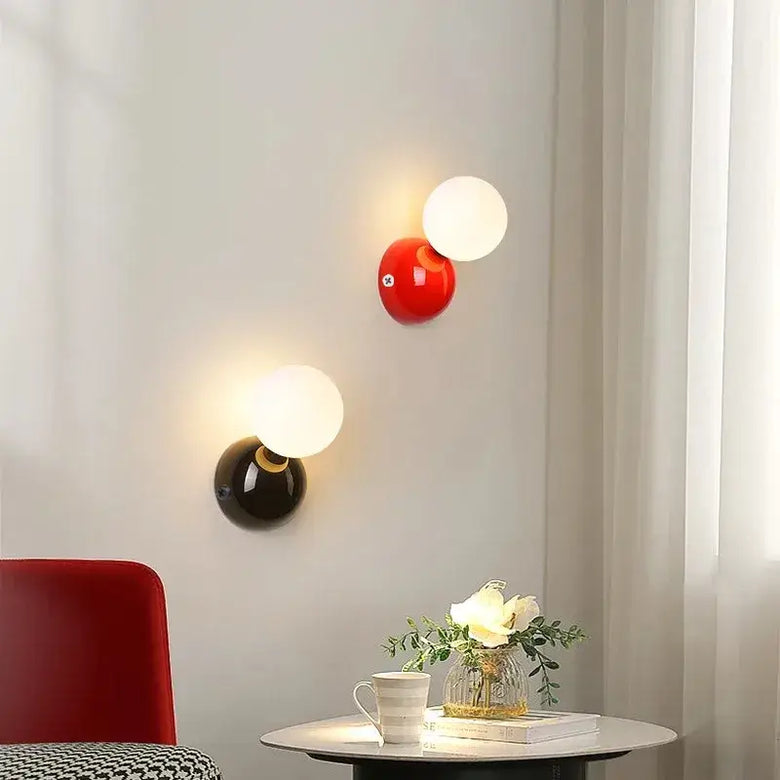70s revival wall lamp in 3 different colours featuring red, black, and frosted glass designs in a modern living space.
