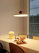 Modern Minimalist Pendant Lamp – Elegant Bedside & Dining Room Lighting illuminating a dining table with food and flowers.
