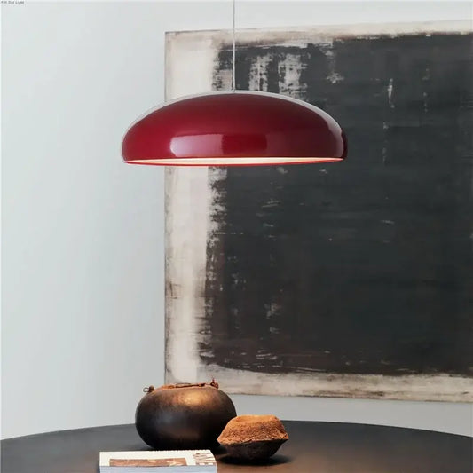 Simple Hanging Lamp in glossy red finish illuminating a modern dining setting with elegant decor.