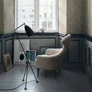 Danish Designer Grasshopper Floor Lamps illuminating a cozy corner with a stylish chair and art on the walls.