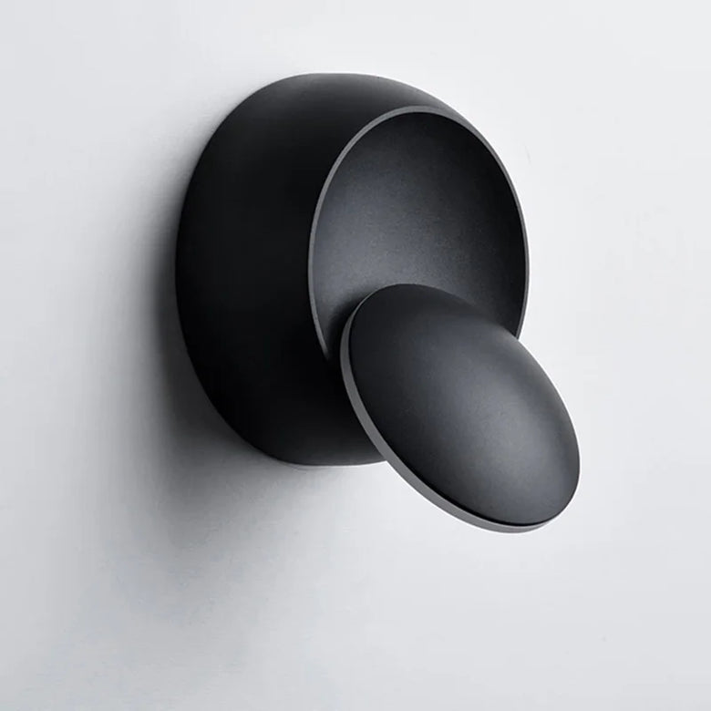 Black wall-mounted round scounce on a light gray background