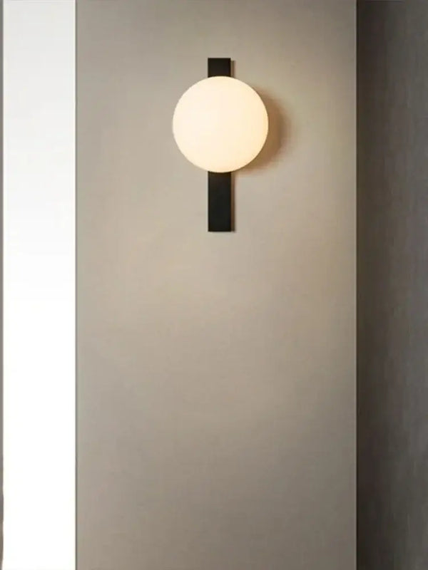 Minimalist Nordic Wall Lamp with Frosted White Ball on a wall, showcasing modern design and simple elegance.