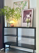Mushroom LED USB Table Lamp in Pink – Soft Glow Bedside Lighting next to a plant and framed artwork on a cabinet.