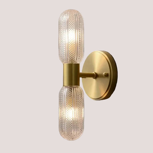 Radiant Luxe Gold Wall Sconce with sleek gold finish and clear glass, enhances chic indoor settings with warm, adjustable lighting.