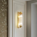 Bathroom Art Deco Brass and Crystal Sconces mounted on a wall, illuminating the elegant design.