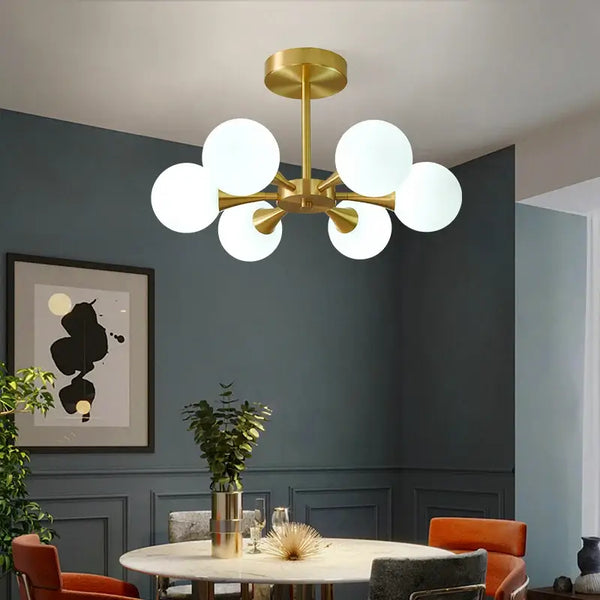 Modern Copper Glass Ball Chandelier in a stylish dining room with frosted glass shades and gold accents.
