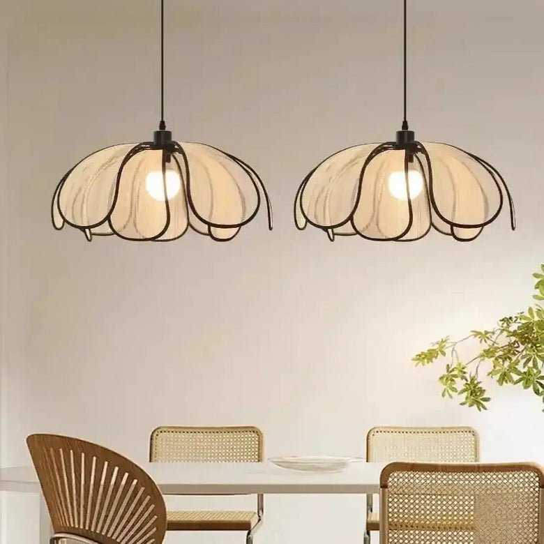 Black and White Rattan Flower Lamp Shade hanging in a minimalist dining area, showcasing Nordic Wabi Sabi design.