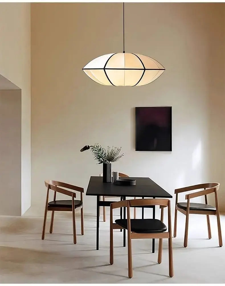 Zen Silk Pendant Light Mid Century Fabric Lantern gracefully illuminating a stylish dining room setting.