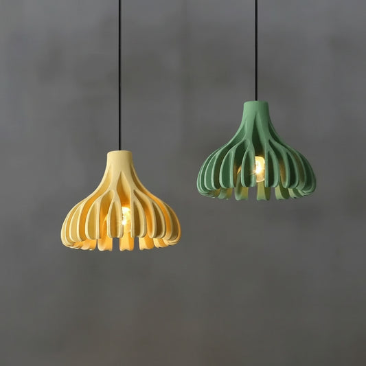 hero Two pendant lights, one yellow and one green, hanging against a gray background.