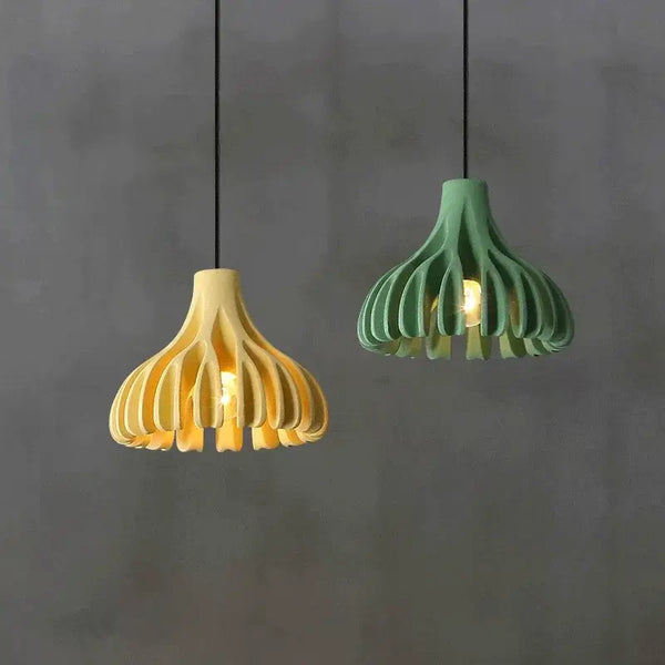 hero Two pendant lights, one yellow and one green, hanging against a gray background.