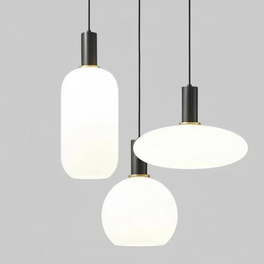 hero Three modern pendant lights hanging against a neutral background