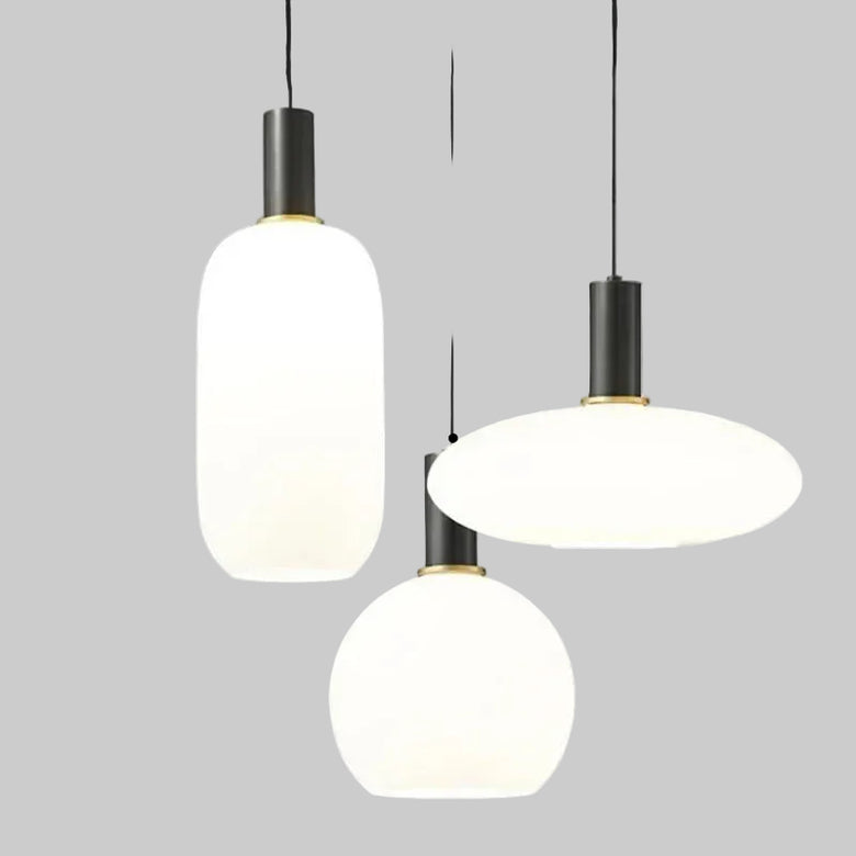 hero Three modern pendant lights hanging against a neutral background