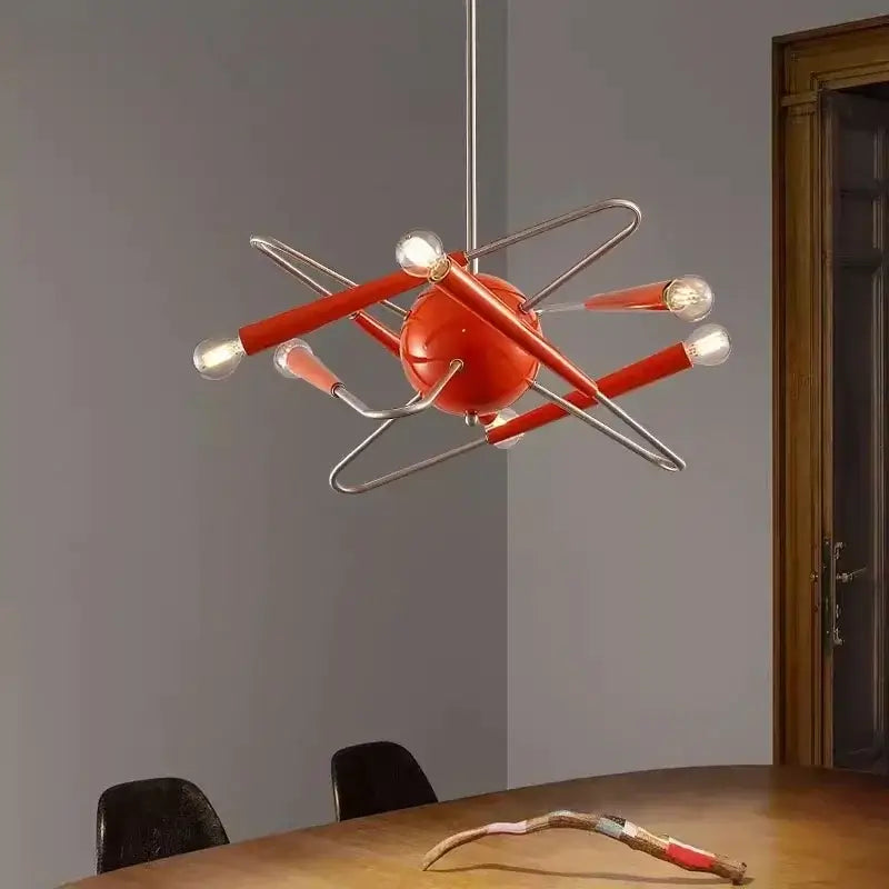 60s Red Sputnik Chandelier hanging above dining table, showcasing bold mid-century modern design with red-orange finish and exposed bulbs.