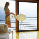 Japanese Rice Paper Table Lamp beside a woman in a serene indoor setting, featuring soft light and elegant design.