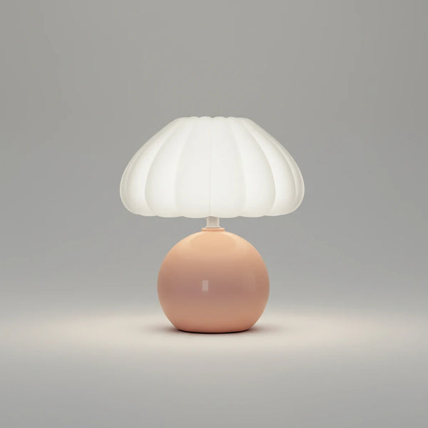 Hero Table lamp with a white shade and pink base on a grey background.