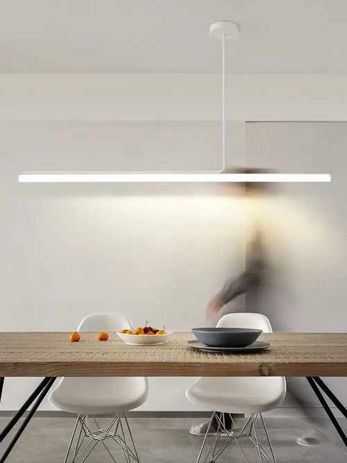 Retro 70s Neon Kitchen Island Pendant in Black or White over a modern dining table with fruit.