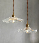 Elegant Glass Pendant Light with Brass Accents - Illuminate with Style, featuring clear glass shades and brass fixtures.