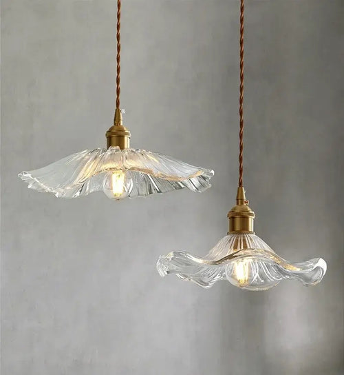 Elegant Glass Pendant Light with Brass Accents - Illuminate with Style, featuring clear glass shades and brass fixtures.