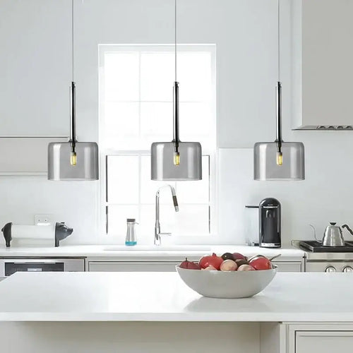 Neo Transparent Scandinavian Light Fixture in a modern kitchen with metallic lampshades.