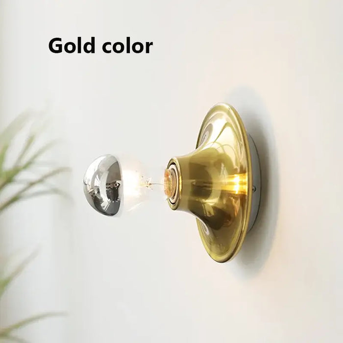 80s revival wall light in gold color showcasing stylish UFO shape and vibrant design.
