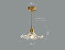 Elegant Glass Pendant Light with Brass Accents - Illuminate with Style, featuring a wavy glass design and brass holder.