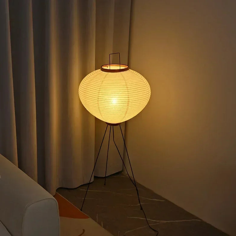 Japanese Rice Paper Lamp. Floor lamp with a warm glow in a dimly lit room.