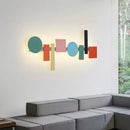 Multicolour Wall Totem LED geometric light illuminating a modern living room with vibrant colors and geometric shapes.